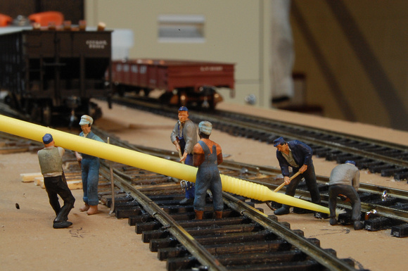 Track Gang using alcohol swab to remove flux from rails.